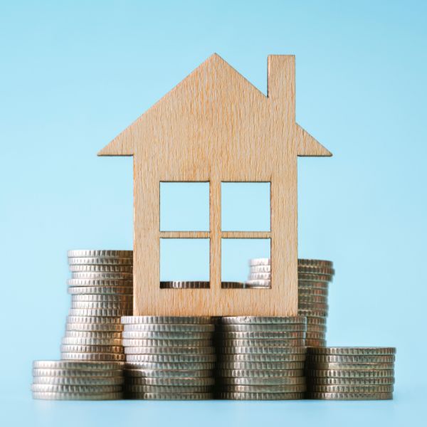 cardboard house ontop of coins