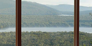 looking out a window over a lake with trees